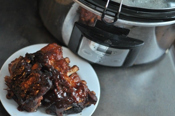 An easy recipe for smoky and saucy BBQ crock pot ribs made right in your slow cooker. Seasoned with a dry rub and brown sugar, these pork baby back ribs are steamed and fall off the bone.