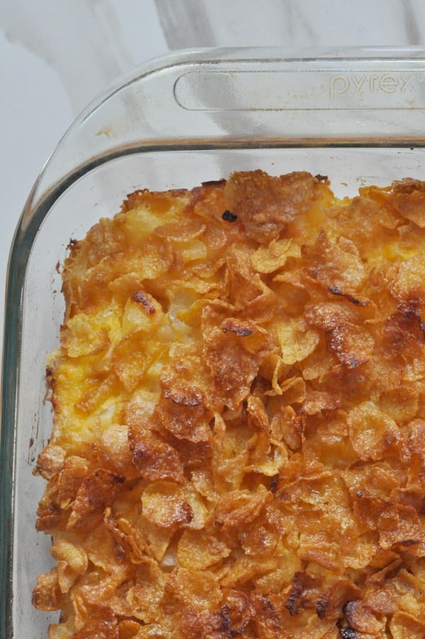 Holiday Classic! Corn Flakes Potato Cheesy Casserole recipe made with cubed hash browns, cheese and sour cream. Super simple and a hit for holiday meals!