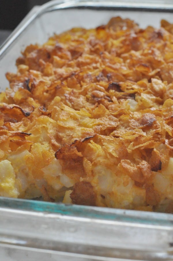 Holiday Classic! Corn Flakes Potato Cheesy Casserole recipe made with cubed hash browns, cheese and sour cream. Super simple and a hit for holiday meals!