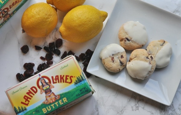 Easy recipe to make White Chocolate Cranberry Cookies. A buttery shortbread cookie with pops of lemon and cranberry and then dipped in white chocolate. https://diningwithalice.com/desserts/white-chocolate-cranberry-cookies/