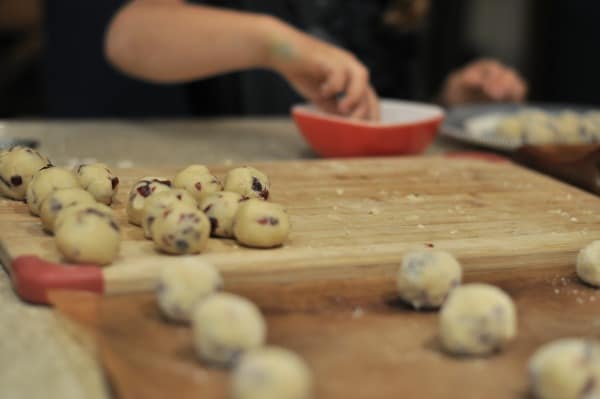 Easy recipe to make White Chocolate Cranberry Cookies. A buttery shortbread cookie with pops of lemon and cranberry and then dipped in white chocolate.