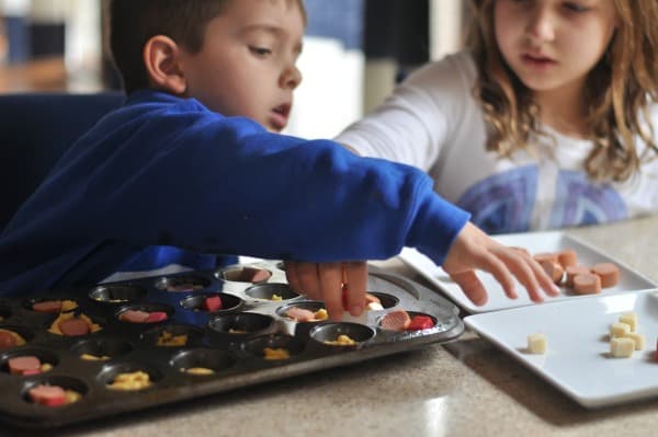 Cheesy Mini Corn Dog muffins kids weeknight meal creative lunch A super easy Cheesy Mini Corn Dog Muffins recipe that makes a great weeknight meal, fun school lunch, or game day appetizer. https://diningwithalice.com/kids/cheesy-mini-corn-dog-muffins/