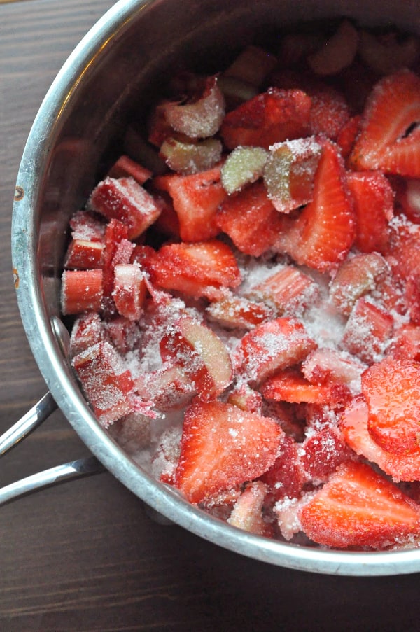 Strawberry Rhubarb French Toast Bake recipe strawberries, rhubarb, and sugar in a saucepan