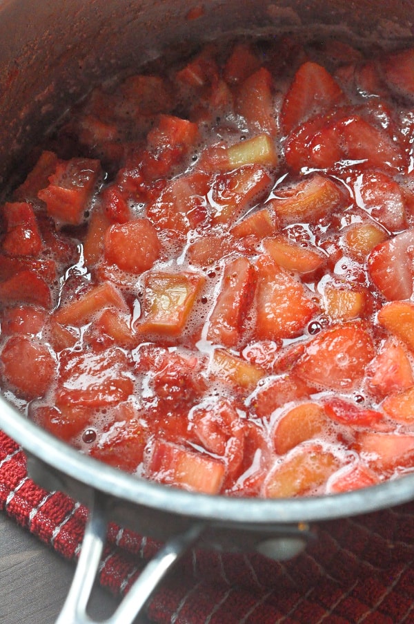 Strawberry Rhubarb French Toast Bake recipe strawberries, rhubarb, and sugar in a saucepan