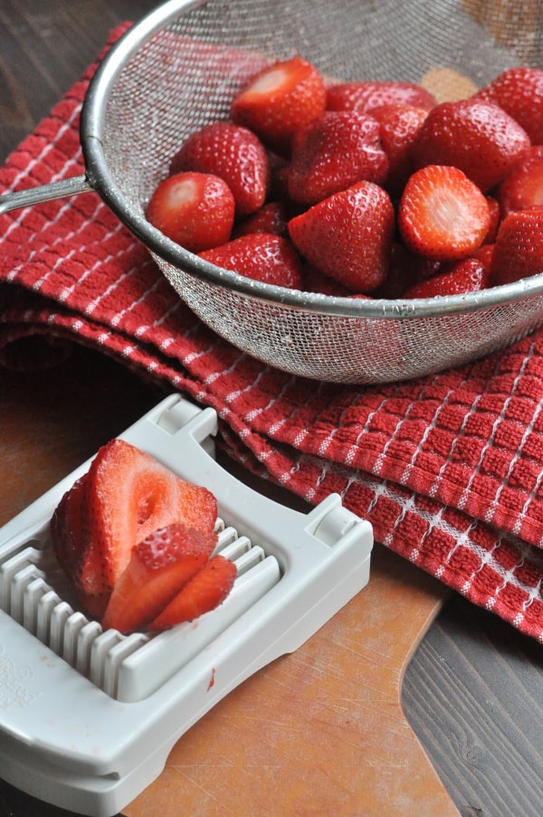 The Pampered Chef Cup Slicer cutting fresh strawberries 