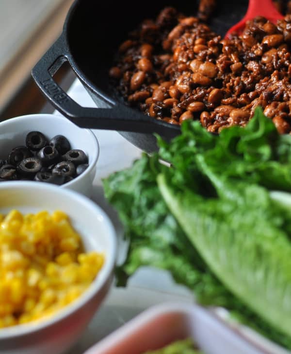 This easy Taco Salad is a quick recipe and is layered with Doritos, ground beef and your favorite taco toppings like olives and corn (shown).