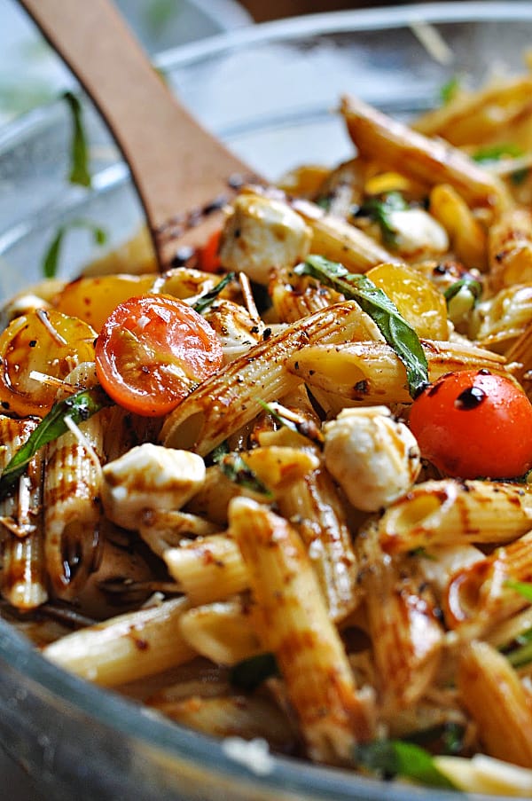 Caprese pasta salad recipe is an easy make-ahead dish for weeknight dinner or potlucks. Made with basil, mozzarella, tomatoes, and balsamic glaze.