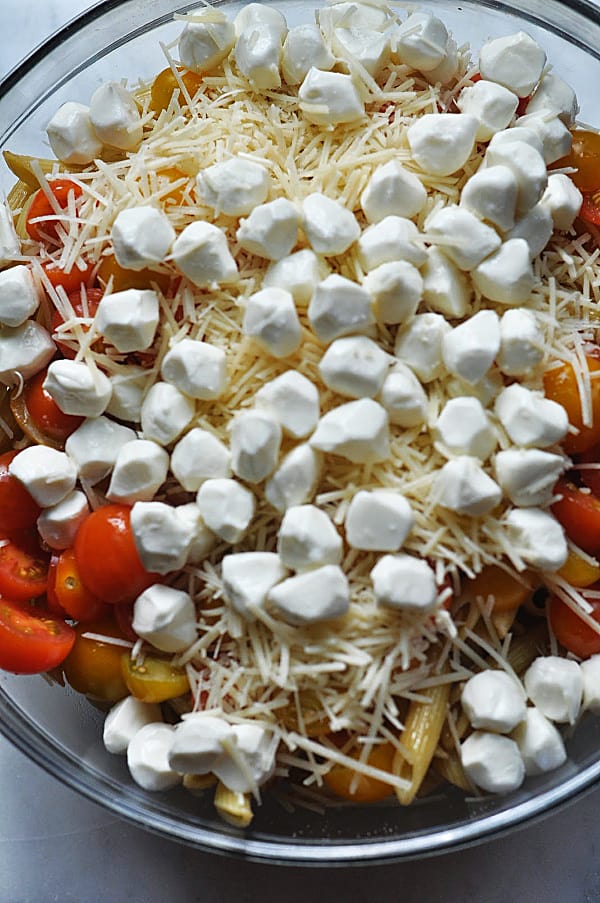 Caprese pasta salad ingredients of mozzarella and parmesan