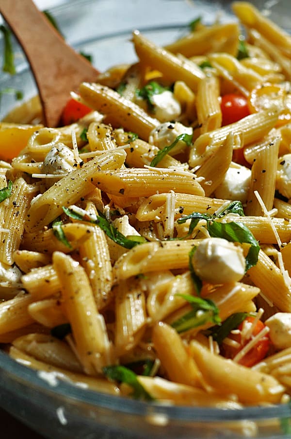 Caprese pasta salad recipe is an easy make-ahead dish for weeknight dinner or potlucks. Made with basil, mozzarella, tomatoes, and balsamic glaze.