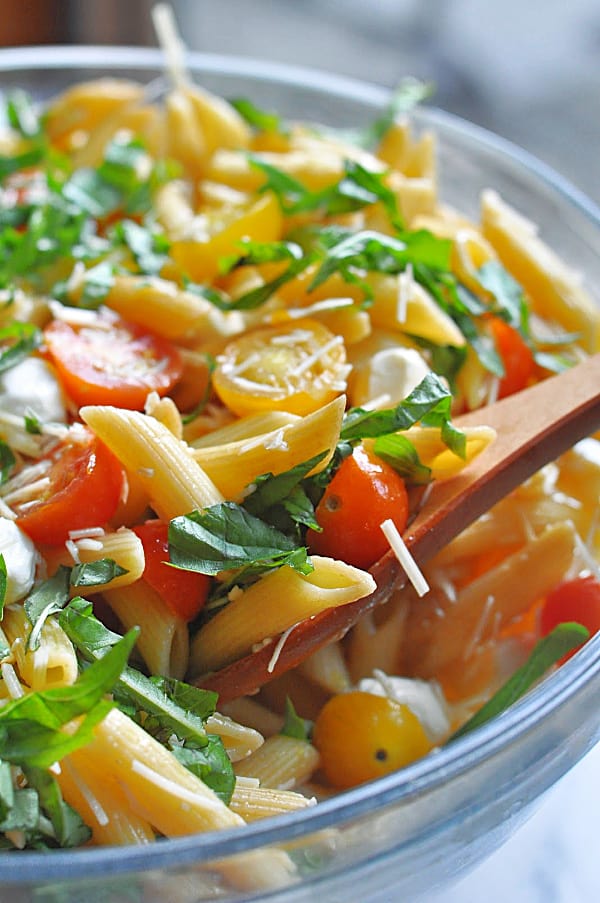 Caprese pasta salad recipe is an easy make-ahead dish for weeknight dinner or potlucks. Made with basil, mozzarella, tomatoes, and balsamic glaze.